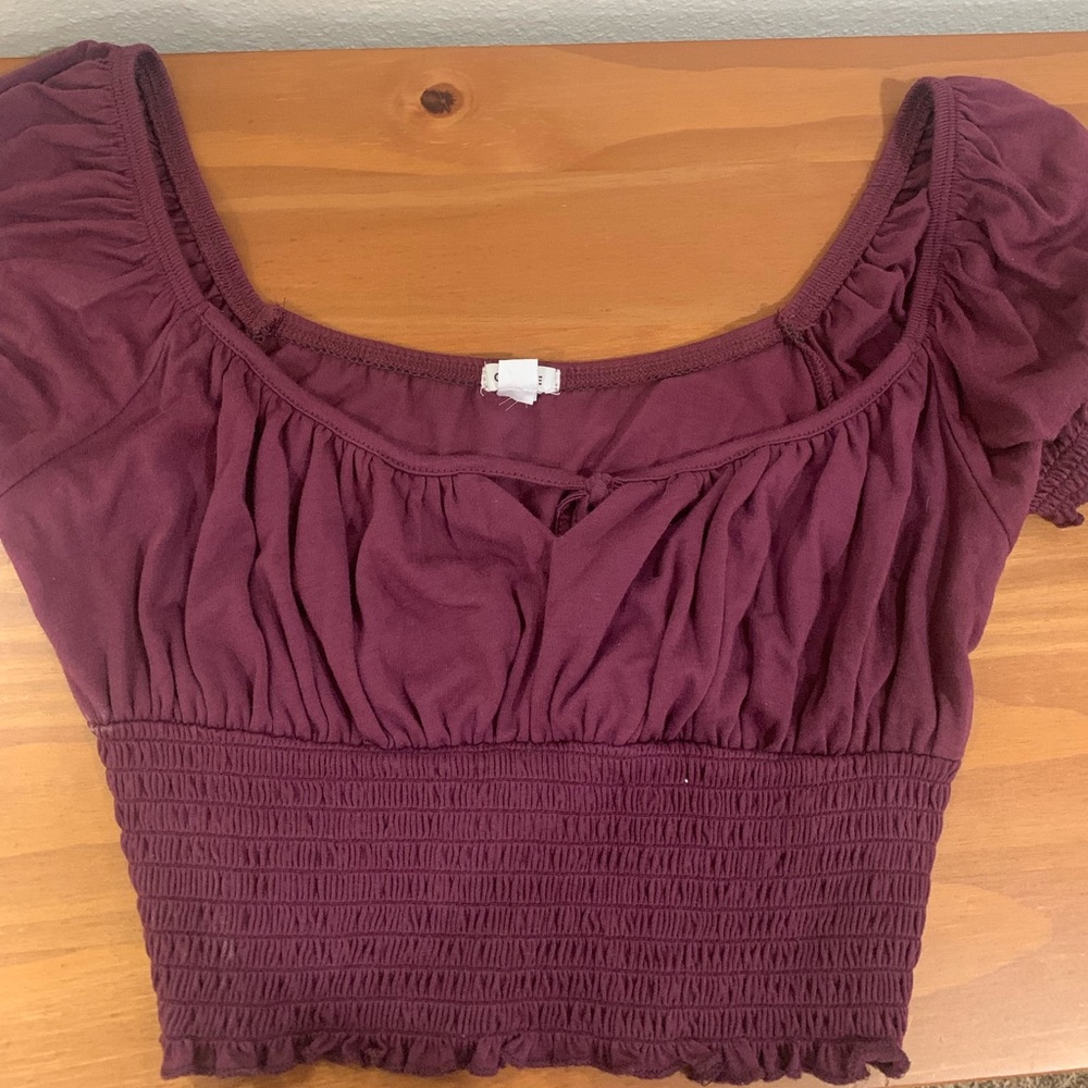 Garage crop top with subtle detailed design.